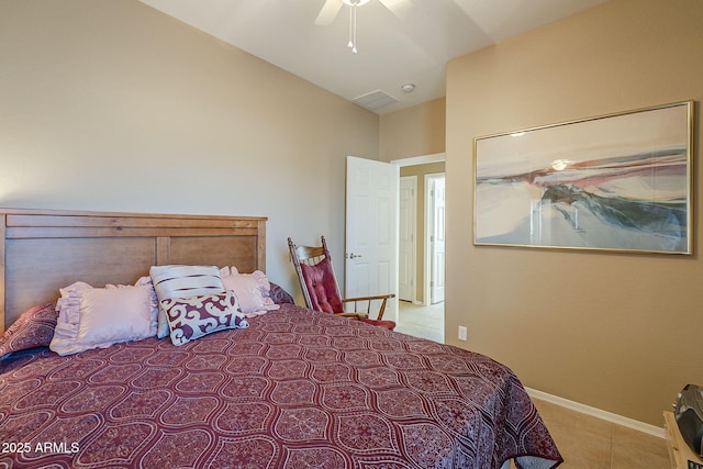 bedroom featuring ceiling fan, light tile patterned floors, and lofted ceiling