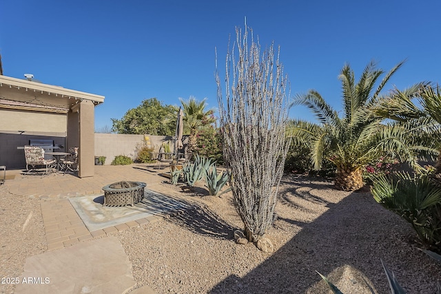 view of yard with a patio area and an outdoor fire pit