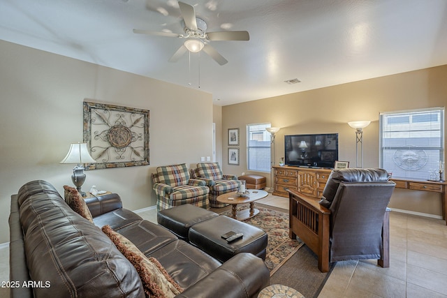 tiled living room with ceiling fan