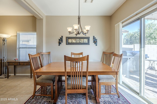 dining area featuring light tile patterned floors and a chandelier