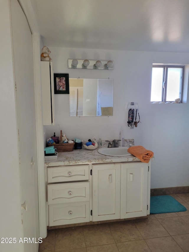 bathroom with tile patterned flooring and vanity