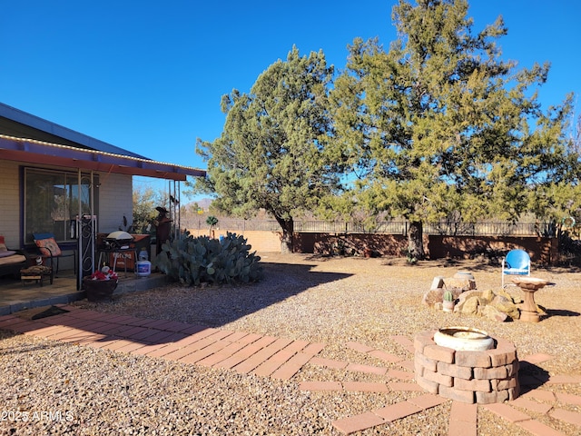 view of yard featuring an outdoor fire pit and a patio area