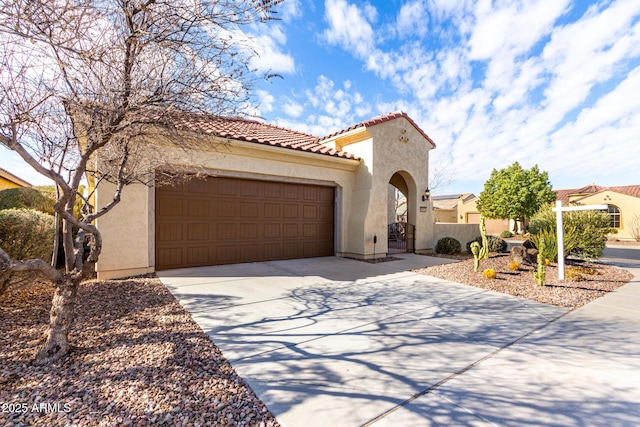 mediterranean / spanish-style house with a garage