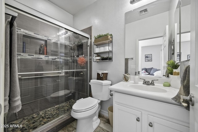43650 W Snow Dr, Maricopa, AZ 85138 - ensuite bathroom featuring vanity, toilet, connected bathroom, a stall shower, and visible vents
