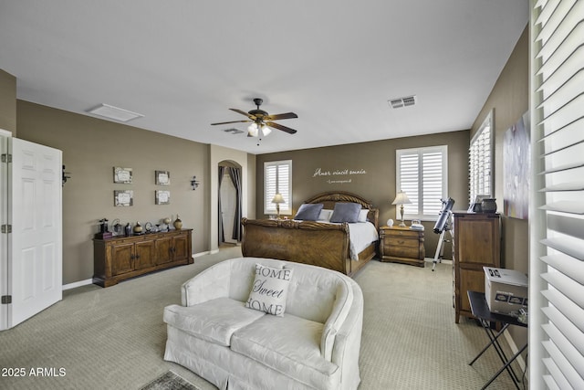 43650 W Snow Dr, Maricopa, AZ 85138 - carpeted bedroom featuring arched walkways, baseboards, visible vents, and a ceiling fan