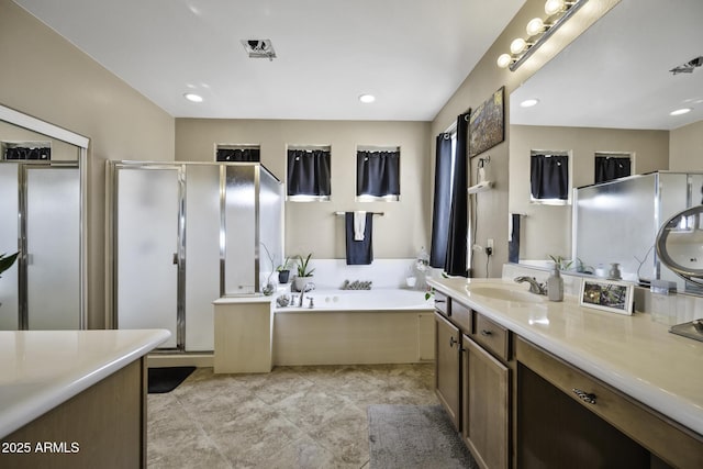 43650 W Snow Dr, Maricopa, AZ 85138 - bathroom featuring a stall shower, recessed lighting, vanity, and a bath