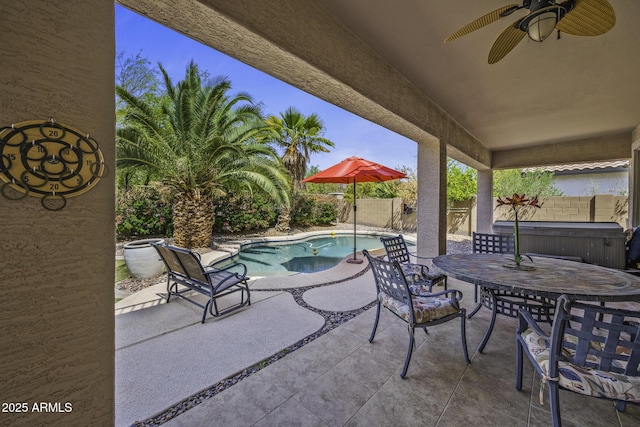 43650 W Snow Dr, Maricopa, AZ 85138 - view of patio featuring a fenced backyard, outdoor dining space, ceiling fan, and a hot tub