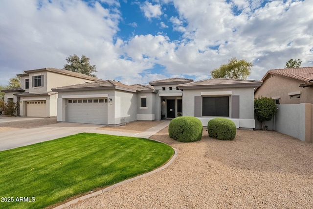 view of front of house with concrete driveway, a front lawn, a garage, and stucco siding