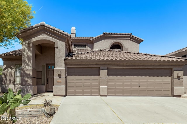mediterranean / spanish-style home featuring stucco siding, an attached garage, a tile roof, and driveway