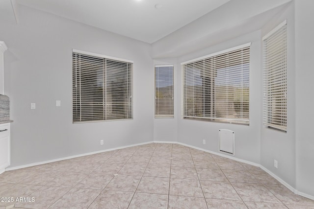 unfurnished room featuring light tile patterned floors