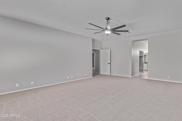 unfurnished bedroom with ceiling fan, baseboards, connected bathroom, and light colored carpet