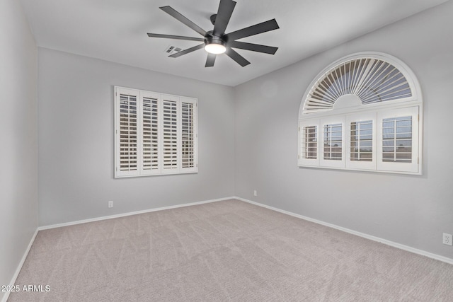 empty room featuring ceiling fan, baseboards, carpet flooring, and visible vents