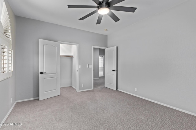 unfurnished bedroom featuring carpet floors, baseboards, and ceiling fan