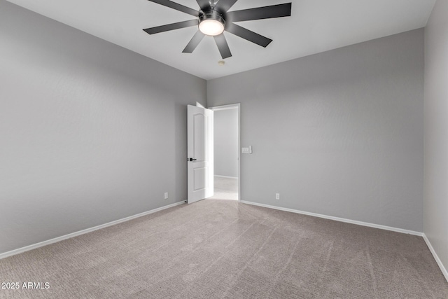 unfurnished room featuring carpet flooring, baseboards, and ceiling fan