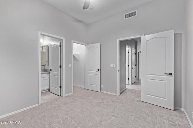 unfurnished bedroom featuring carpet floors, visible vents, and baseboards