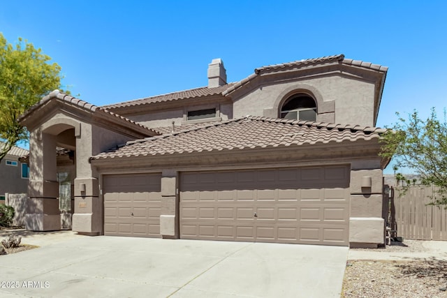mediterranean / spanish house featuring stucco siding, an attached garage, driveway, and a tiled roof