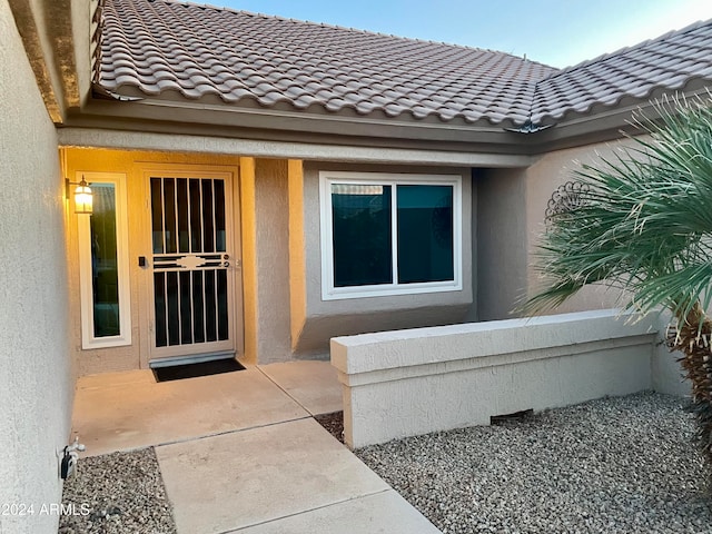 property entrance with a patio area