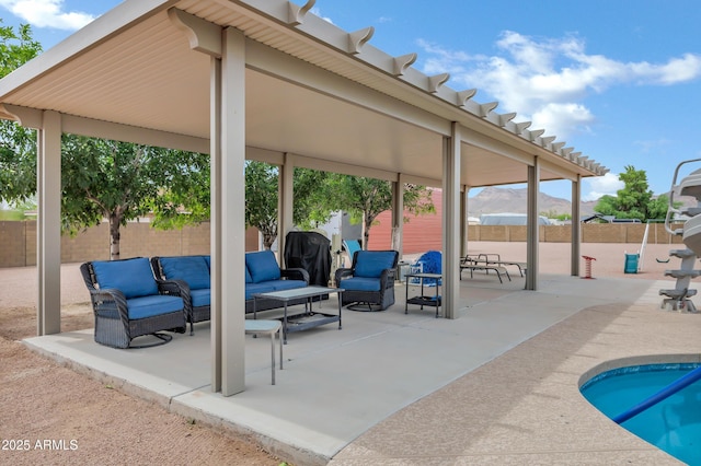 2926 W Smoketree St, Apache Junction, AZ 85120 - view of pool with a patio, an outdoor hangout area, a fenced backyard, and a mountain view