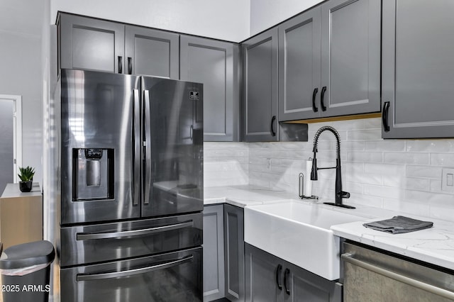 2926 W Smoketree St, Apache Junction, AZ 85120 - kitchen with appliances with stainless steel finishes, a sink, tasteful backsplash, light stone countertops, and gray cabinetry