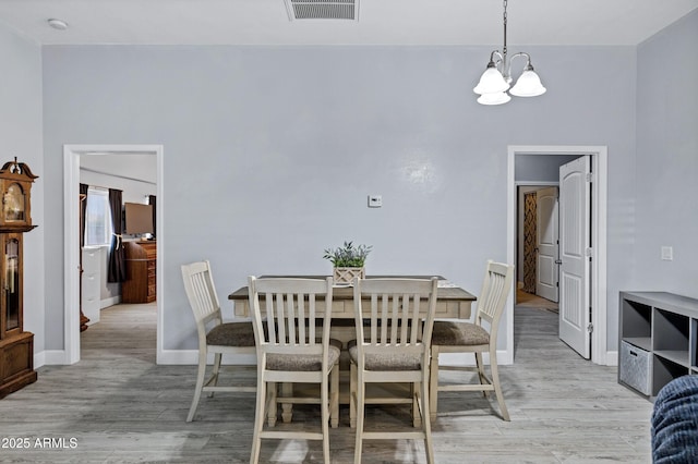2926 W Smoketree St, Apache Junction, AZ 85120 - dining space featuring a chandelier, light wood-style flooring, and baseboards