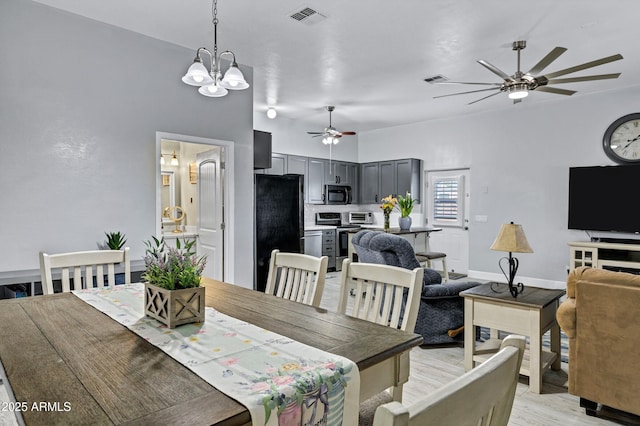 2926 W Smoketree St, Apache Junction, AZ 85120 - dining room featuring ceiling fan, a chandelier, light wood-style flooring, and baseboards