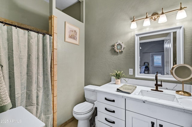 2926 W Smoketree St, Apache Junction, AZ 85120 - bathroom featuring toilet, a textured wall, vanity, and curtained shower