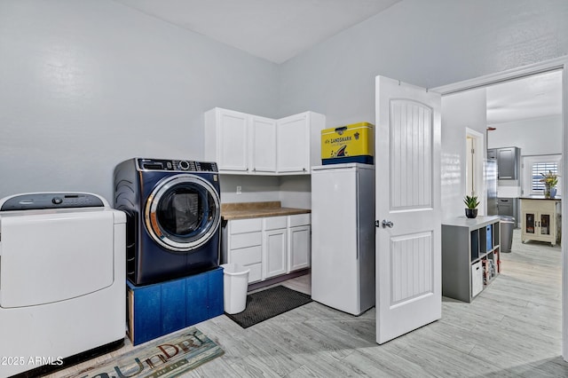 2926 W Smoketree St, Apache Junction, AZ 85120 - laundry room featuring washing machine and clothes dryer, cabinet space, and light wood-type flooring