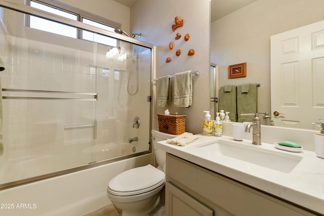 full bathroom with enclosed tub / shower combo, vanity, and toilet