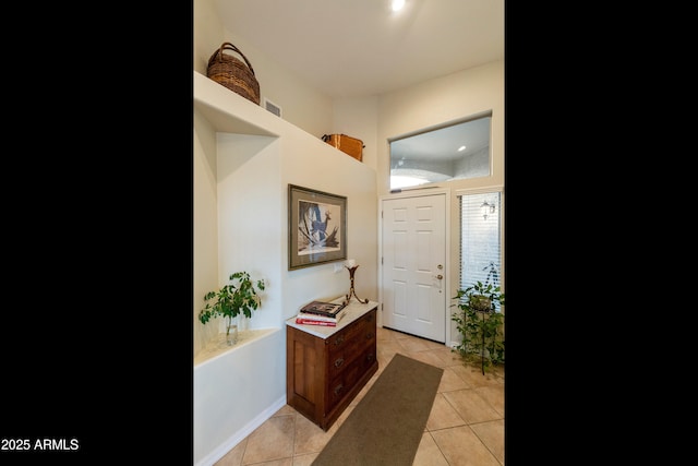 doorway featuring light tile patterned flooring