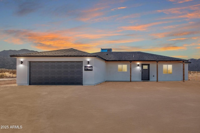 prairie-style home featuring a garage