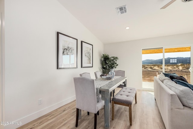 dining space featuring a mountain view and light hardwood / wood-style floors