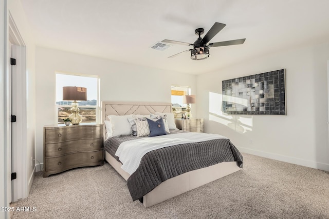 carpeted bedroom featuring ceiling fan and multiple windows