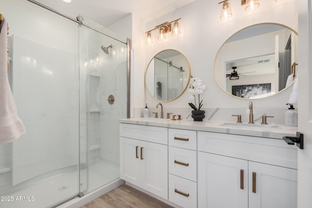 bathroom with vanity, wood-type flooring, ceiling fan, and walk in shower