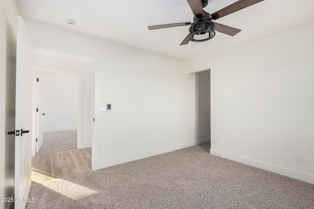 spare room featuring light carpet and ceiling fan