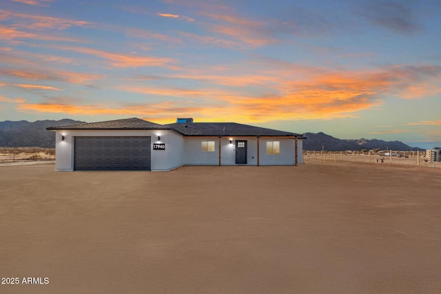 prairie-style house featuring a garage and a mountain view