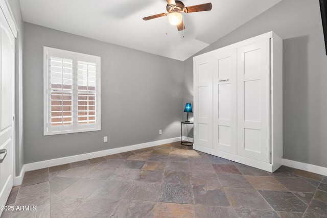 unfurnished bedroom featuring ceiling fan, a closet, and vaulted ceiling