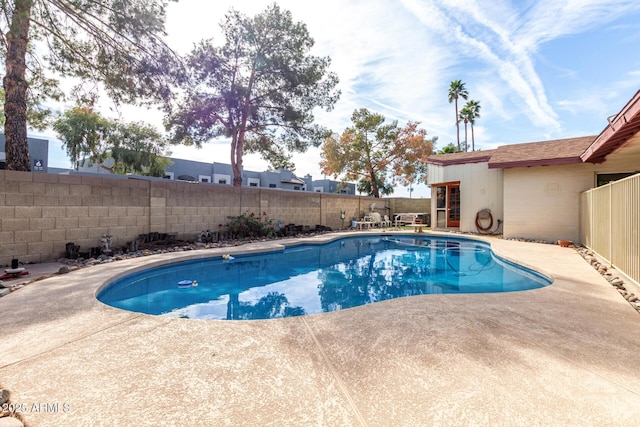 view of swimming pool featuring a fenced backyard, a fenced in pool, and a patio