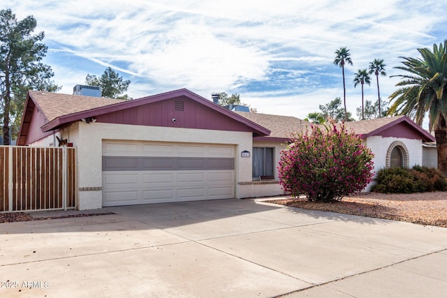 single story home featuring roof with shingles, stucco siding, concrete driveway, an attached garage, and cooling unit