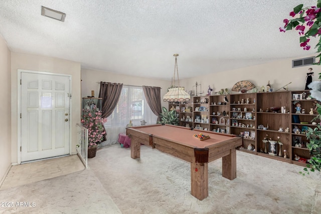 rec room with a textured ceiling, light carpet, billiards, and visible vents