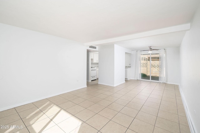 empty room featuring light tile patterned floors, visible vents, a ceiling fan, and baseboards