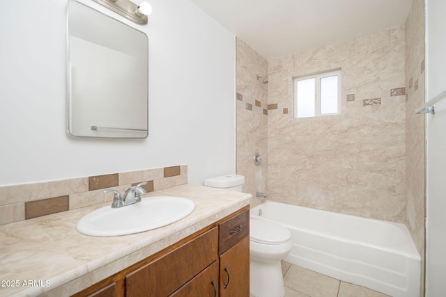 bathroom with tile patterned floors, vanity, toilet, and  shower combination