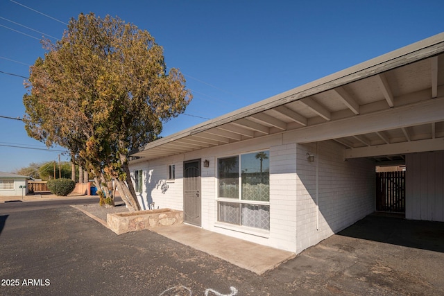 doorway to property featuring concrete block siding