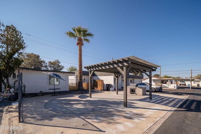 view of patio / terrace featuring a pergola and fence
