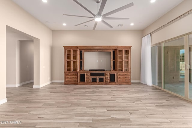 unfurnished living room featuring ceiling fan