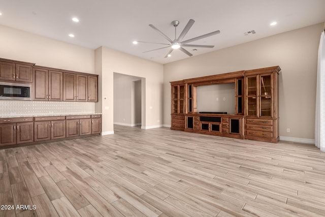 unfurnished living room with light hardwood / wood-style floors and ceiling fan