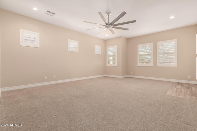 carpeted empty room featuring ceiling fan