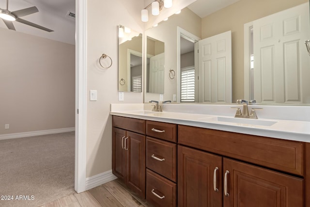 bathroom featuring ceiling fan, wood-type flooring, and vanity