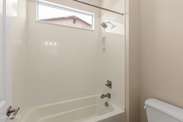 bathroom featuring shower / tub combination and toilet