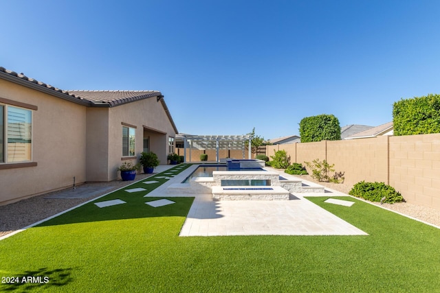 view of yard featuring an in ground hot tub and a patio