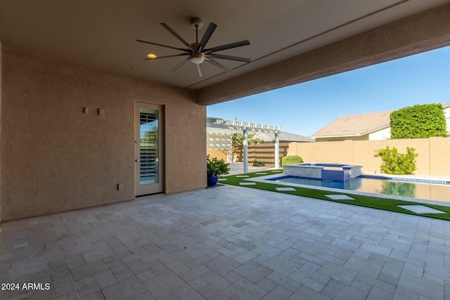 view of patio / terrace featuring ceiling fan and a pool with hot tub